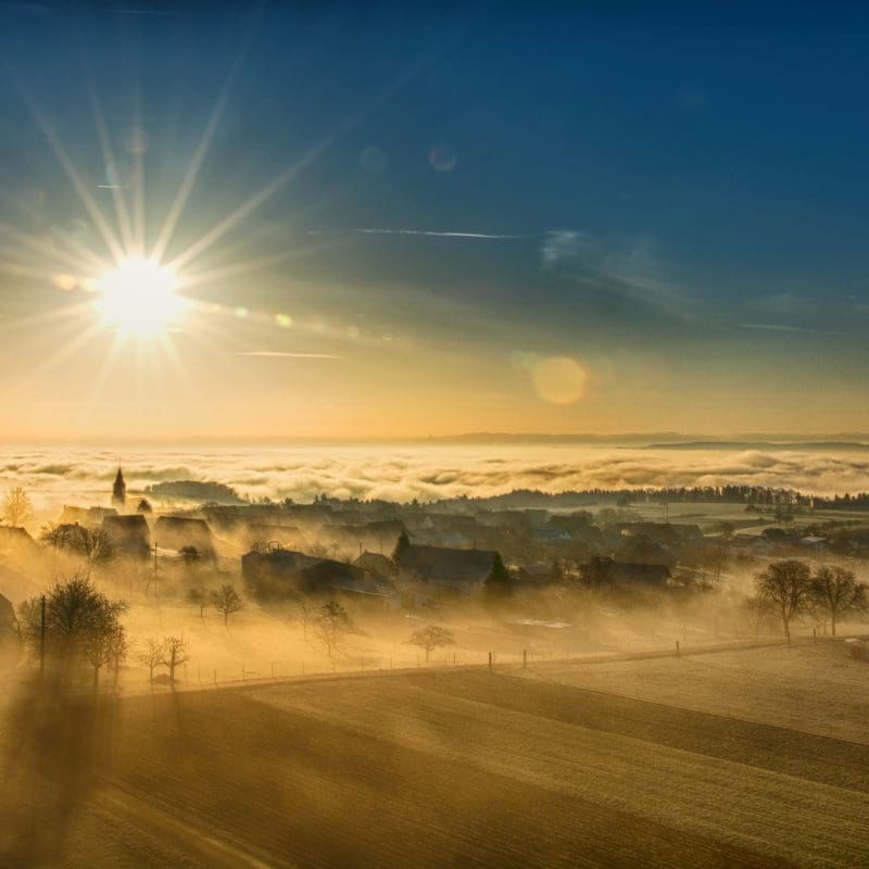 early morning mist over village